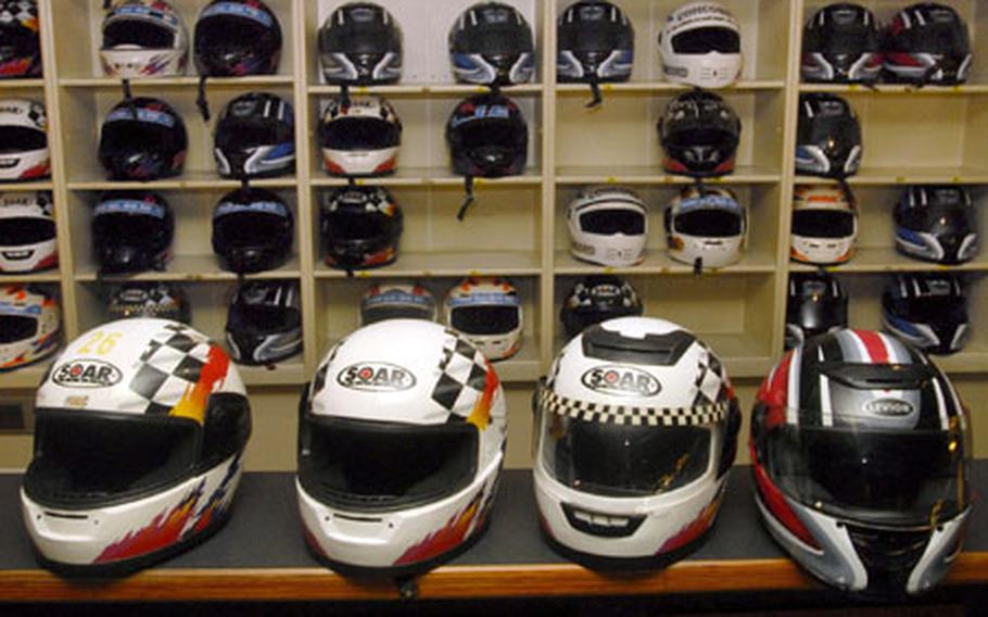 A row of helmets sit on the counter at Go! Indoor Kart after a race. After purchasing a helmet liner, you are given a full-face helmet as protection in the case of a crash.