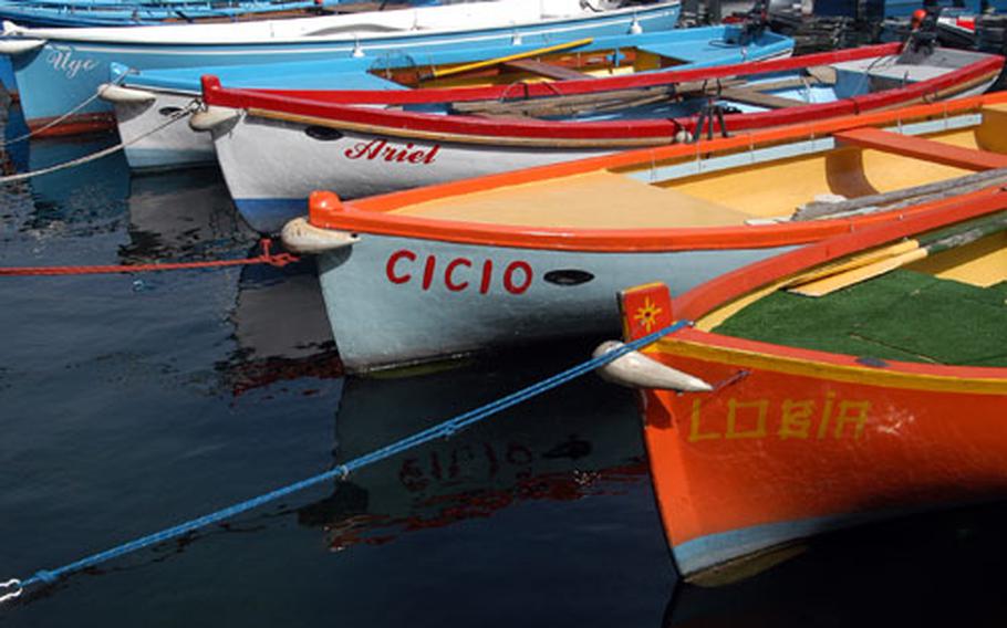 Colorful boats moored in the Castelletto di Brenzone, Italy, harbor. Castelletto is a picturesque village, one of 16 that make up the community of Brenzone, on the eastern shore of Lake Garda
