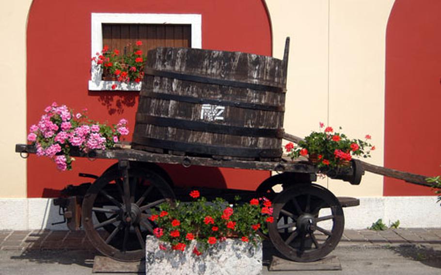 An old wine cask on a wagon decorates the Zeni winery and museum in Bardolino, Italy. You can tour through the museum with its old wine casks, grape presses and bottling equipment and then taste and buy the wines produced there.