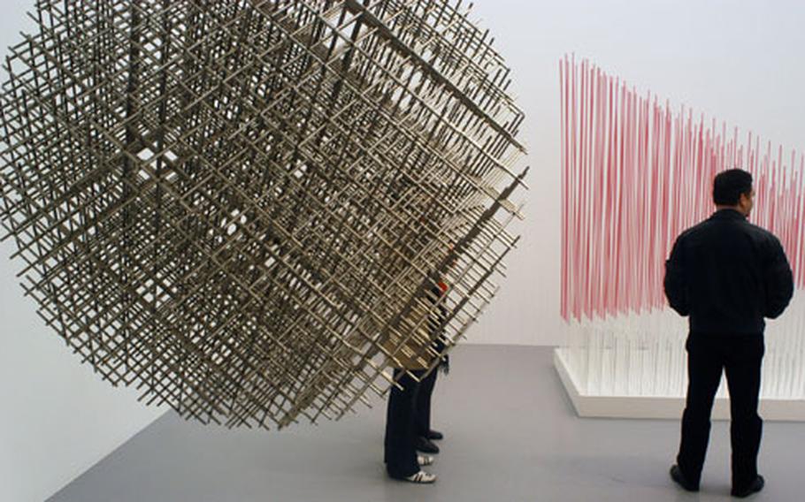 Two sculptures by French François Morellet, left, and Spaniard Jesus Rafael Soto.