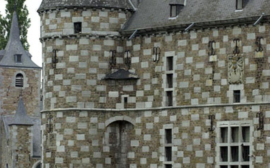 Jehay Castle in Amay, Belgium, dates to the 16th century in its present form. The castle is surrounded by a moat and is open to tourists. Its unusual checkerboard facade is a result of alternating blocks of white limestone and brown sandstone.