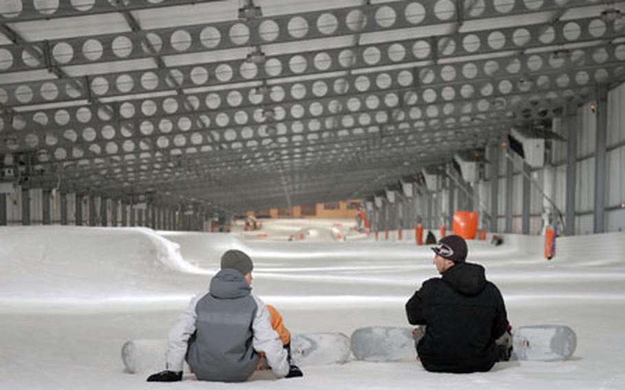 Snowboarderss prepare to make a quick run at Snowhall, Europe’s longest indoor ski run June 6, 2007, in Amnéville, France. The half-kilometer hill is peppered with an assortment of rails and jumps available year-round.
