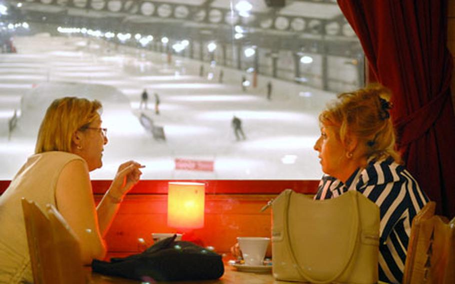 Guests enjoy a café next to the scenic view of the Snowhall slope, Europe’s longest indoor ski run June 6, 2007, in Amnéville, France.