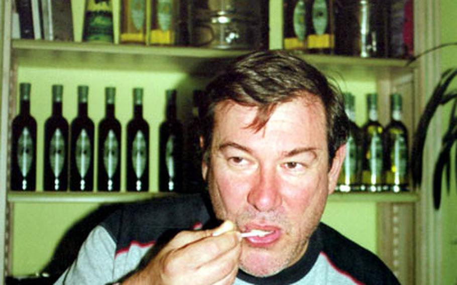 Jean-Benoit Hugues tastes the olive oil he helps produce, Castelas Huile d’Olive A.O.C. de la Vallée des Baux de Provence, a premier olive oil that has won numerous prizes.