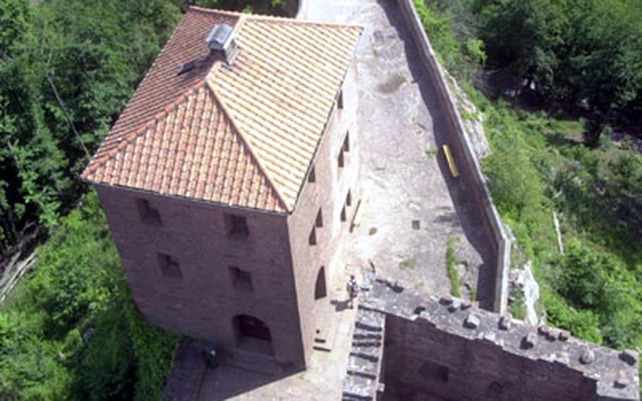 A view from Burg Trifels&#39; main tower shows just how narrow the rocky ledge is that the castle rests upon. In the upper corner of the photo is the parking lot from where visitors must take a roughly 20-minute hike to get to the castle.
