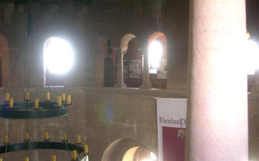 A stone column supports an arch inside Burg Trifels&#39; expansive ballroom. An exhibit at the castle provides the history of English King Richard the Lion Heart, who was held captive at the castle in 1193.