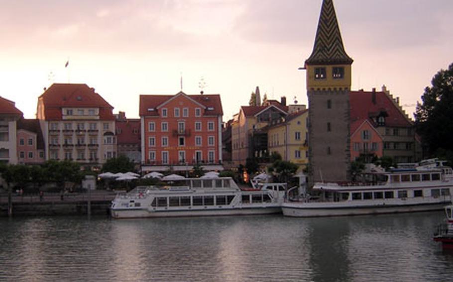 The hues of the sunset match the color of the facades of some of the hotels on the harbor front at Lindau, Germany. At right is the Mangturm, a 13th-century lighthouse and tower built to protect the harbor.