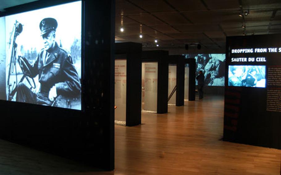 Screens of all sizes flash footage of the preparations for and execution of Operation Overlord at the new visitor center at the Normandy American Cemetery. Free-standing displays tell the stories of the various parts of the invasion in both English and French.