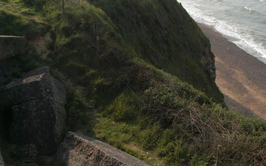 The ruins of a German bunker, part of the "Atlantic Wall," overlook cliffs that drop into the English Channel. On D-Day, 255 Army Rangers led by Lt. Col. James E. Rudder scaled the cliffs to take out German artillery that had threatened the American invasion beaches, but the Germans had already moved the guns inland.