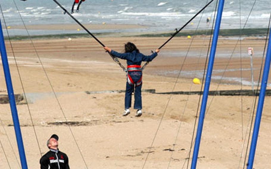 Low tide at the beach of Cabourg at the Côte Fleurie is a good time to play on an elaborate swing.