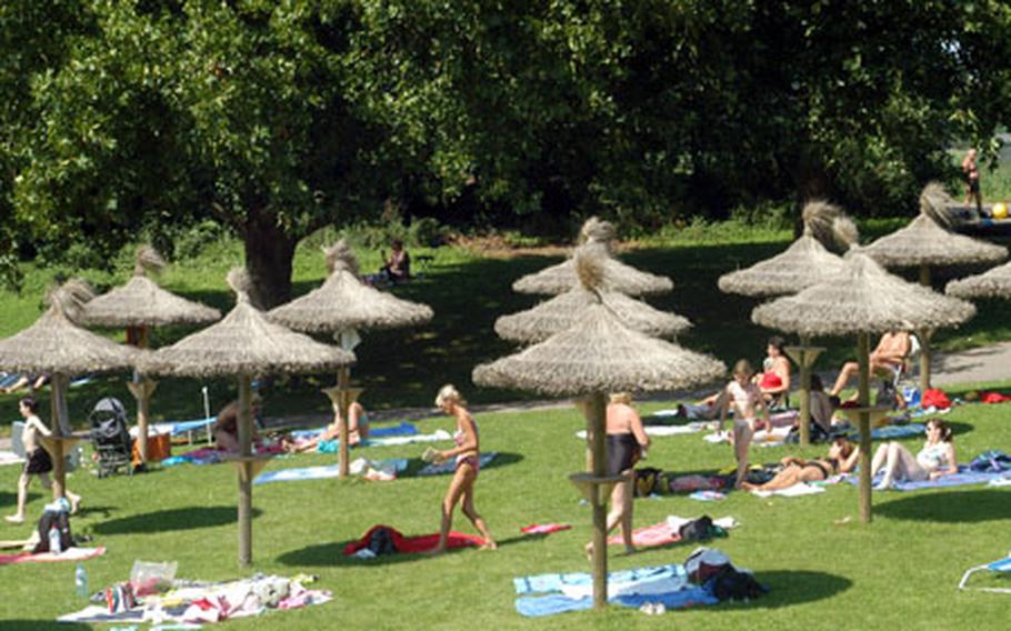 Tiny tiki huts give a festive air and shade if you need it at the Strandbad Waidsee, near Heidelberg, Germany.