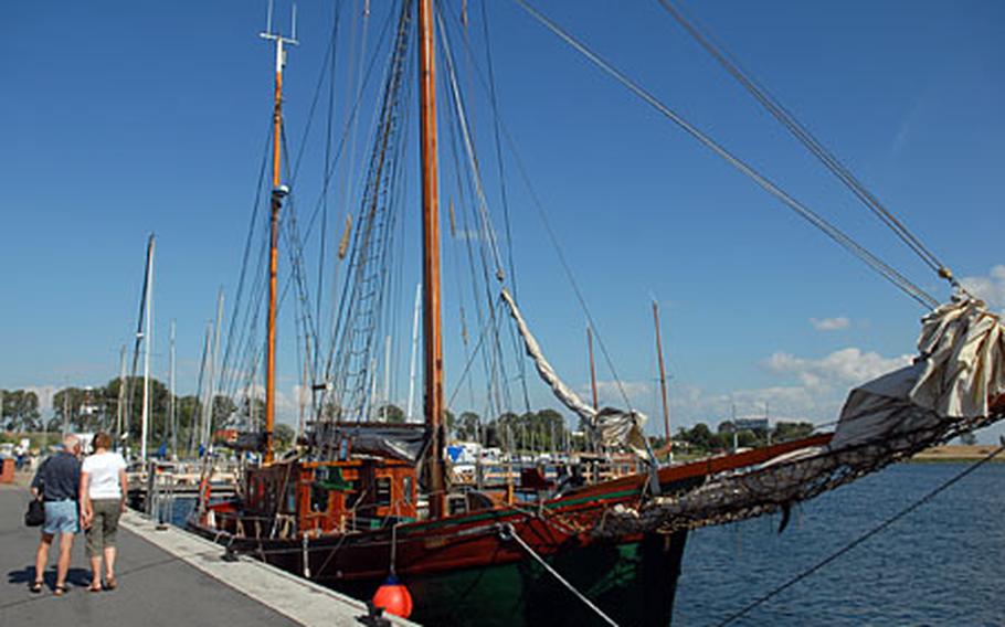 Visitors check out an old sailing vessel moored in Kirchdorf harbor.