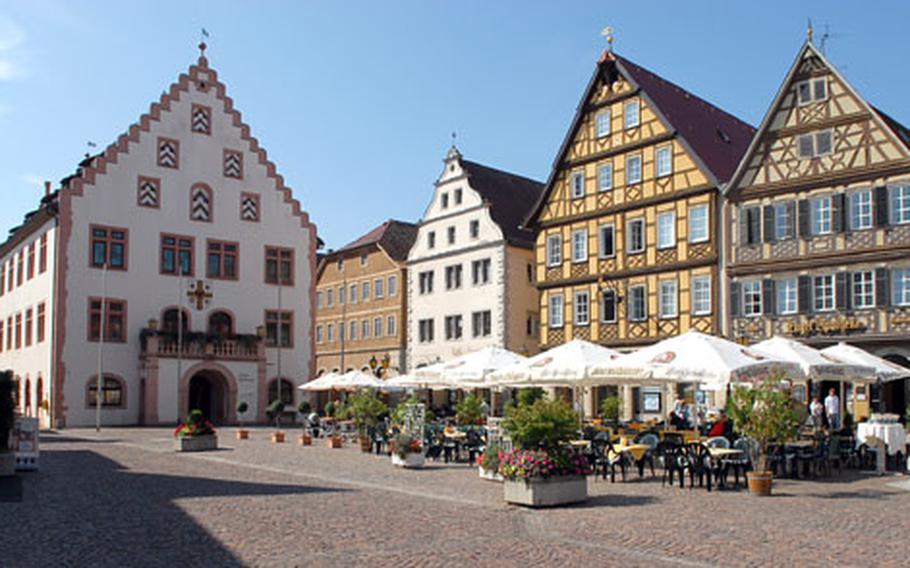 The Marketplatz, or market square in Bad Mergentheim features restaurants, cafes, half-timbered houses and the Renaissance old Town Hall, left, with its staggered gable architecture.