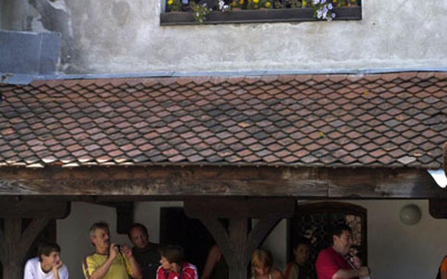 Tourists overlook the courtyard in Bran Castle in Romania.
