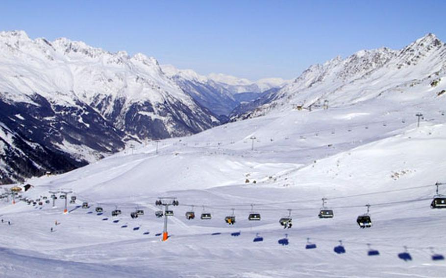 The high altitude of the Marmolada glacier brings good snow and spectacular views. In the background is the Sella mountain, site of the famous Sella Ronda ski carousel.