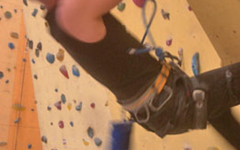 Tim Göritz makes his way up a climbing wall at Camp 4 in Zweibrücken, Germany, as Christian Carbon stands below as his belayer. The indoor climbing facility has more than 200 climbing routes and a bouldering room with a padded floor. It’s housed in the old movie theater on the former U.S. air base in Zweibrücken.