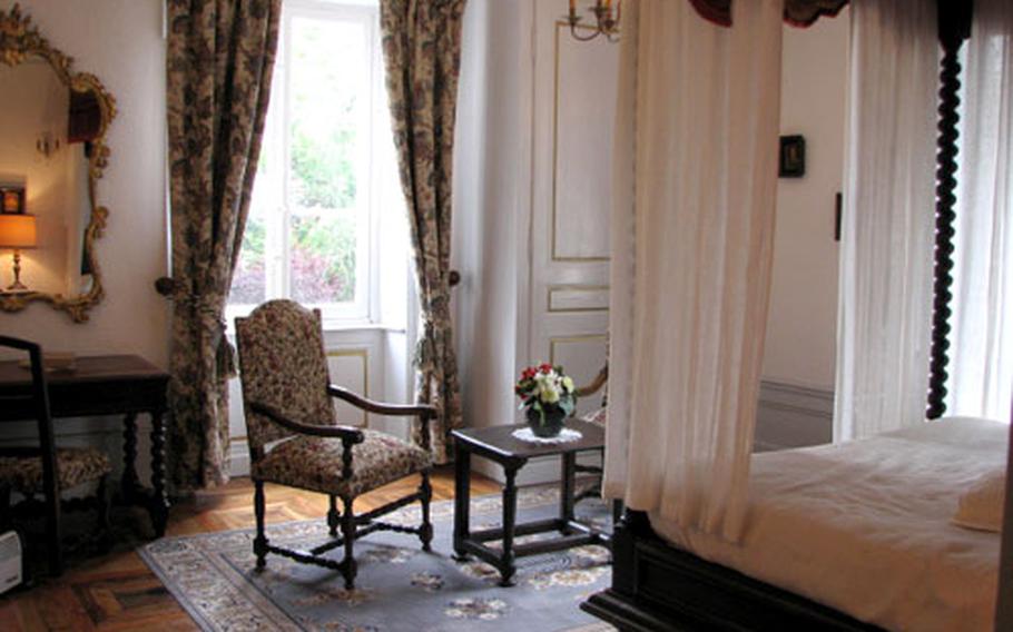 The Lafayette bedroom at Chateau de la Chapelle des Bois features an enormous canopied bed.