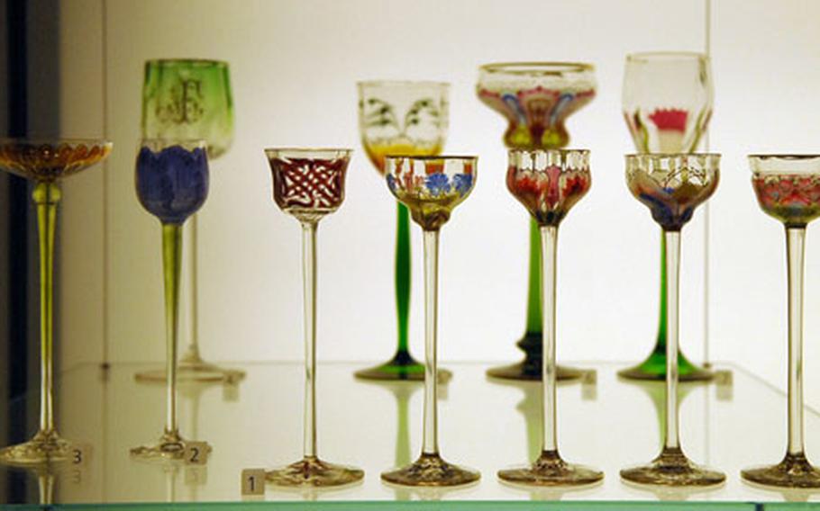 Art Nouveau liqueur glasses (front), and wine glasses, all from about 1900.