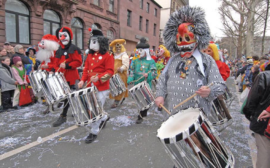 These strange-looking fellows marching in the Rosenmontag parade in Mainz, Germany, are called Guggemusiker and are known for their off-key playing.