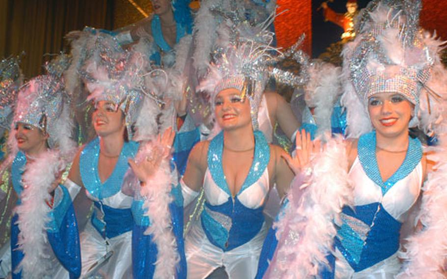 Red and White Sparkles performers in their “Ice” costumes dance while their “fire” outfits are hidden underneath.