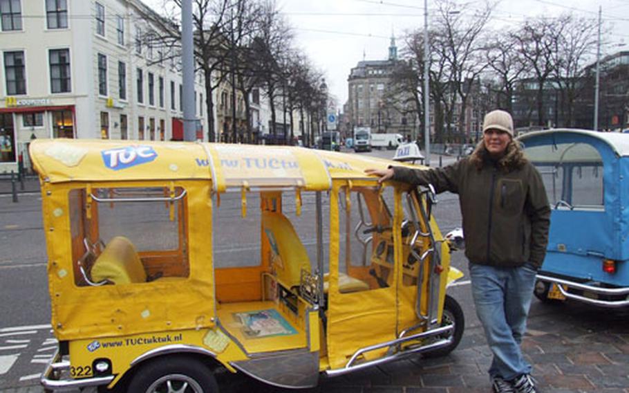 Bibi Anouk-Claushuis stands by her tuk-tuk, an "auto-rickshaw." She manages the company which has 20 of the Southeast Asian vehicles in The Hague.