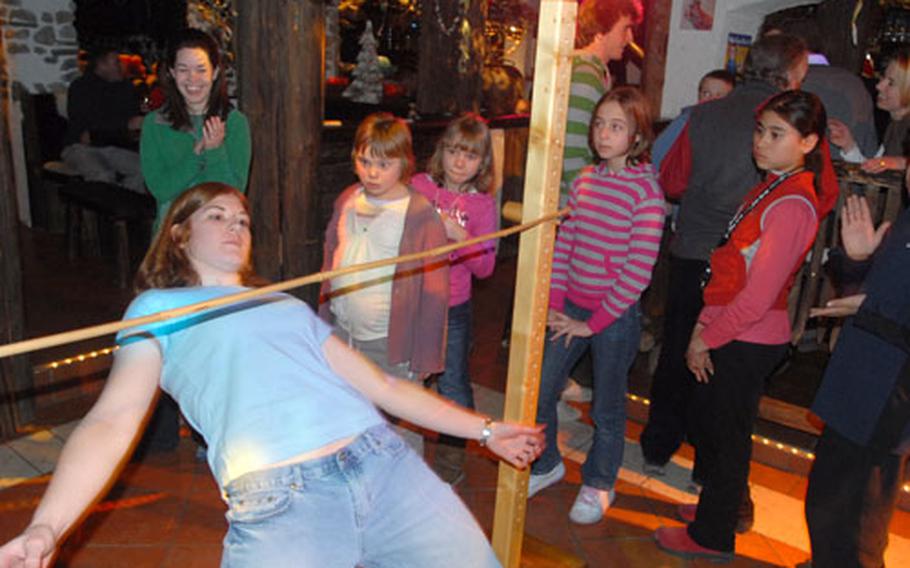 Skier Dawn Will of Grafenwöhr, Germany, does the limbo during aprés- ski activities on a trip with Siegi Tours during Presidents Day weekend.