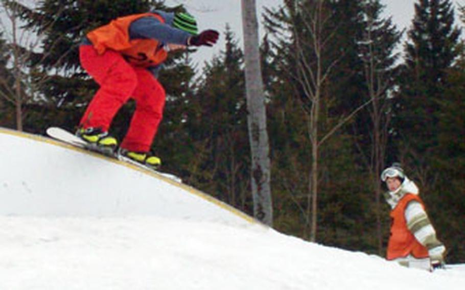 A snowboarder rides a rail at the Grosser Arber ski area in Germany.