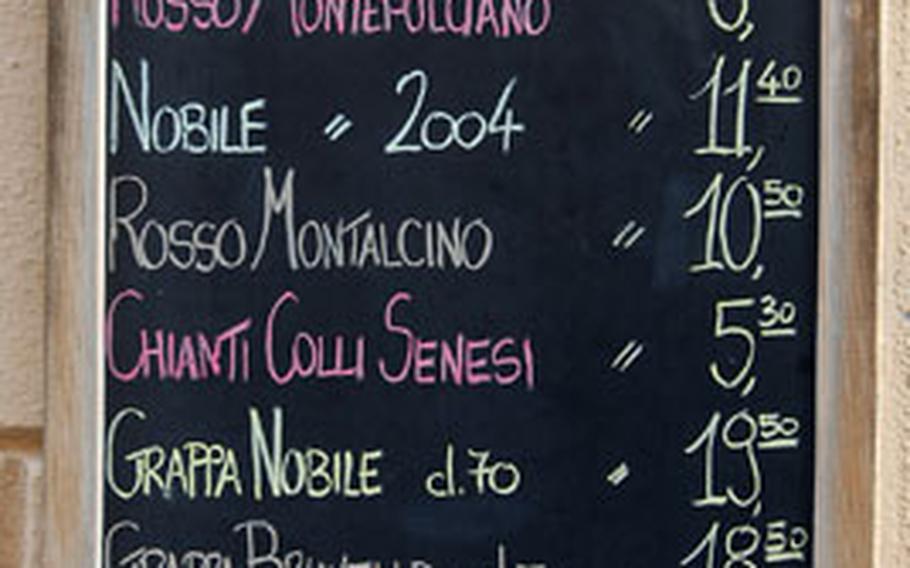 A sign on a wine shop in Montepulciano announces which Tuscan wines are available for sale. Although Tuscany is known for its red wines, it is also home to whites and blends.