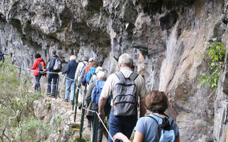 A Walking Festival group follows the Vereda da Ilha trail up a Madeira mountside along a 200-year-old levada.