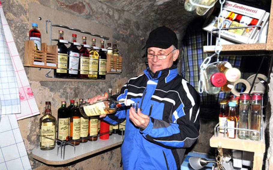 Georg Eichenauer serves schnapps and bitters to customers in his little shop atop the Hinterturm. He sells a variety of "firewaters" and souvenirs for those who come to see Schlitz and the surrounding area from the tower.