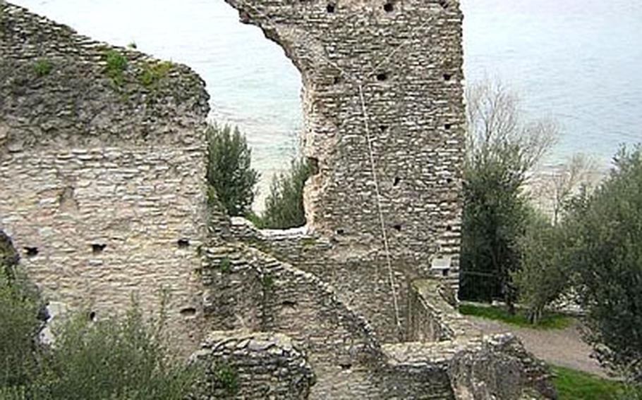 The old town of Sirmione is behind the towers of the 13th-century fortress, the Castello Scaligero. Only those with business or a hotel room inside the walls are permitted to drive across the bridge into the town.