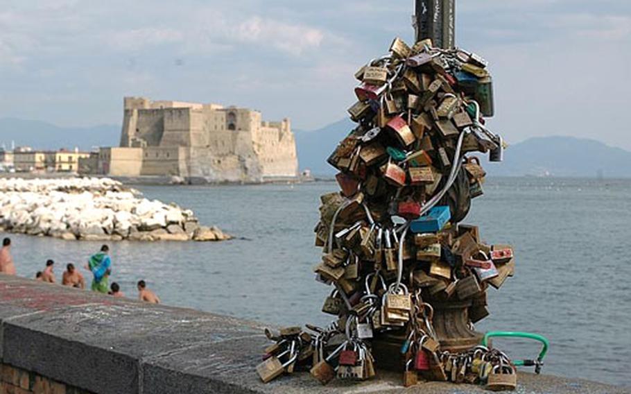 The lamp posts along the coastal street of Via Francesco Caracciolo are crowded with padlocks, many inscribed with the names of couples pledging their love.