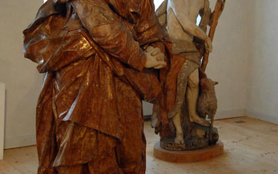 Statues of a grieving Mary, left, and of John the Baptist, done in the 18th century by Burkard Zamels, are on display in the monastery museum at Kloster Eberbach.