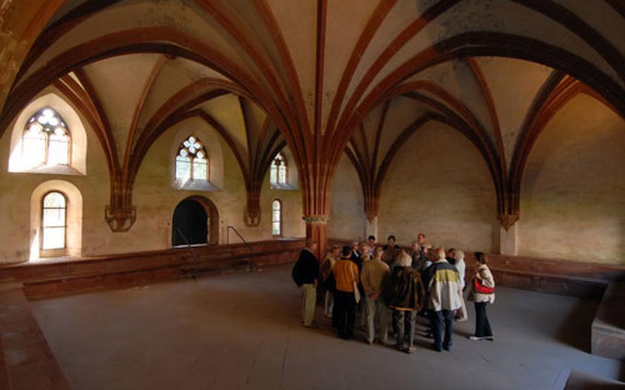 A tour group listens as their guide talks about the chapter house at Kloster Eberbach. The vaulted room dates to about 1345.