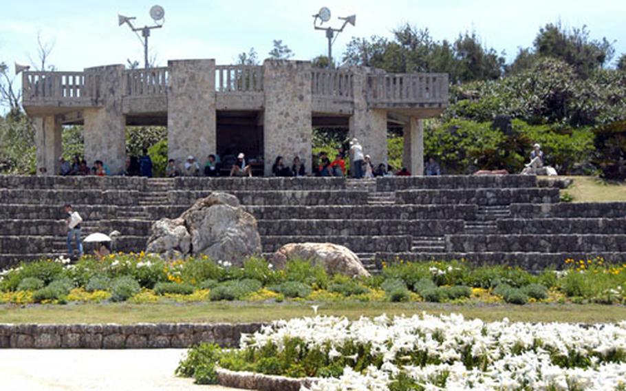 Spectators take in the lilies while enjoying some shade at one of the landmarks at the flower park. More than a million lilies are in bloom and on display during the island’s annual festival, which runs from late April through early May.