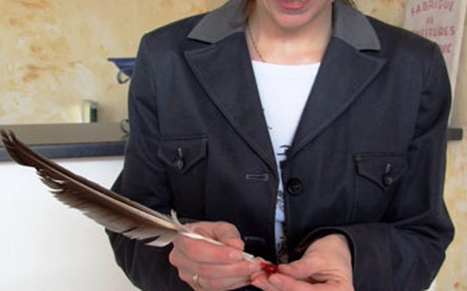 Anne Dutriez, who took over the jam company from her grandfather, demonstrates removing the red currant seeds with a feather during a tour of Confitures à la Lorraine. The recipe for the product is a guarded secret.