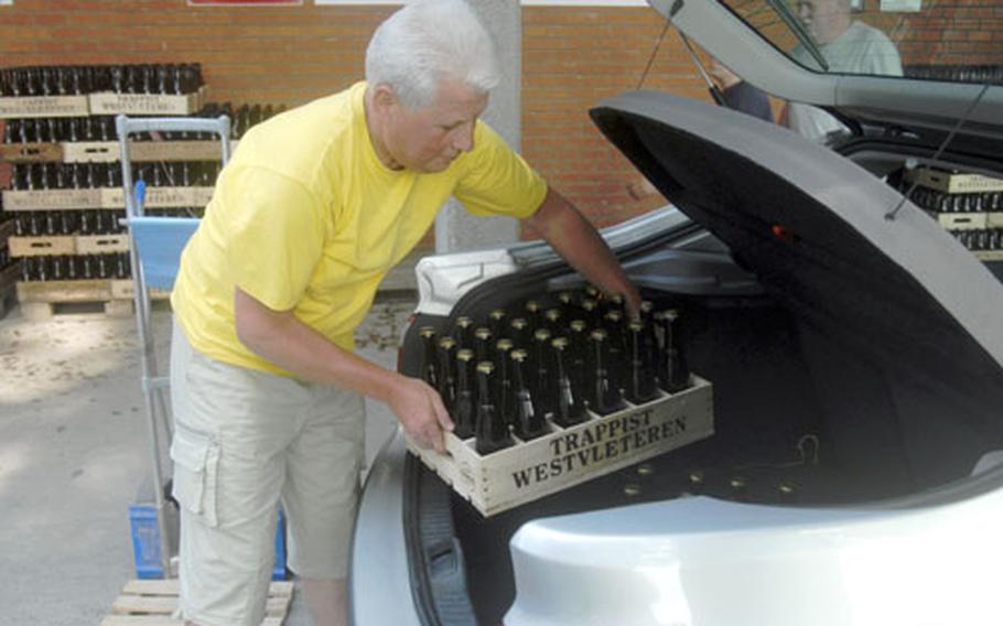 Belgian Robert DeBosscher handles a case of Saint Sixtus’ extremely rare and prized beer, the 12, with utmost care.