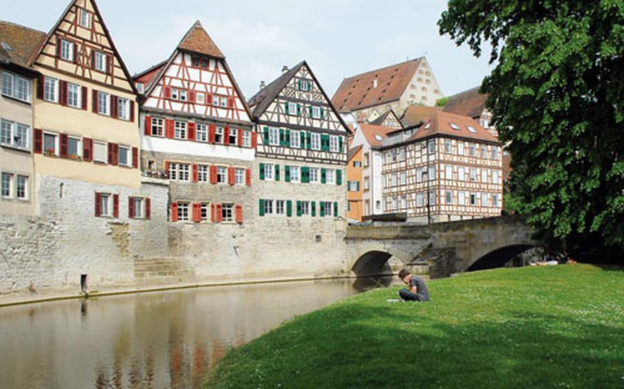 The Kocher River flows through Schwäbisch Hall, with the houses of the old town as a picturesque backdrop. The Grasbädele island, at right, is a popular place to relax.