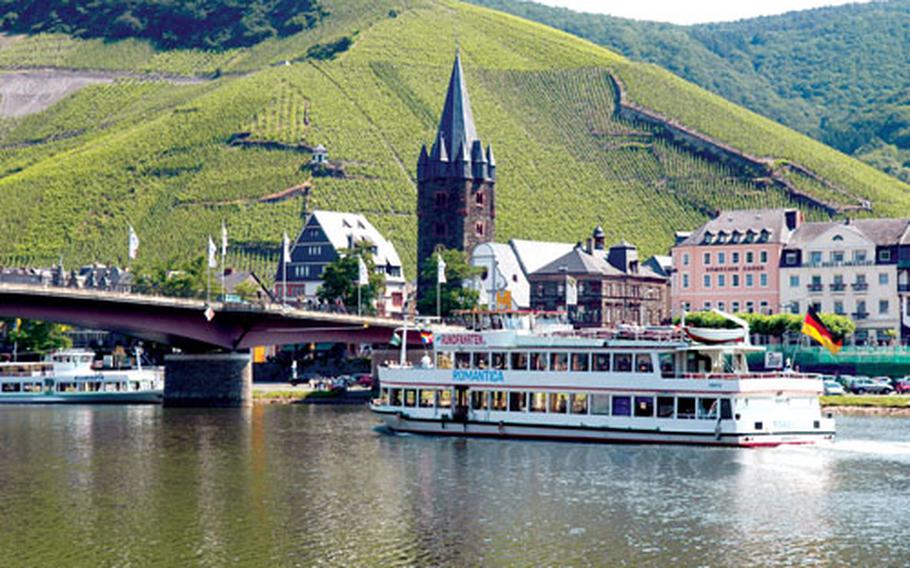 The stone tower, which stands out from across the Moselle River, belongs to St. Michael&#39;s Church. The Catholic parish still holds services. River boats also routinely pass Bernkastel-Kues, a medieval village that dates to the early 13th century.