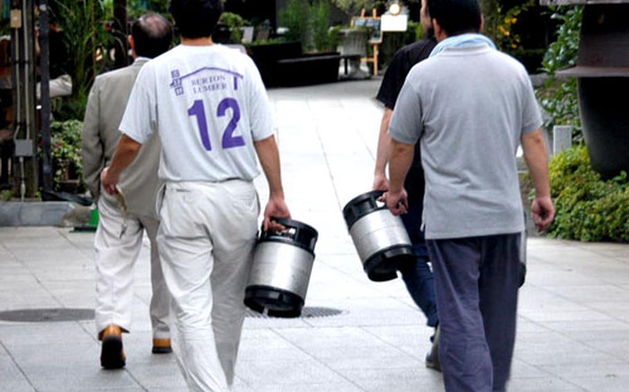 Japanese men show up with empty mini-kegs for refilling at Ishikawa beer garden.