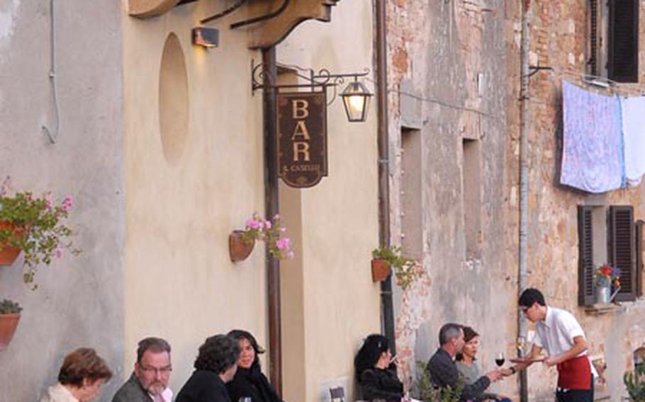 Michael Abrams photo People relax and have a drink at a Pienza, Italy, bar, on a street that goes along the city&#39;s walls.