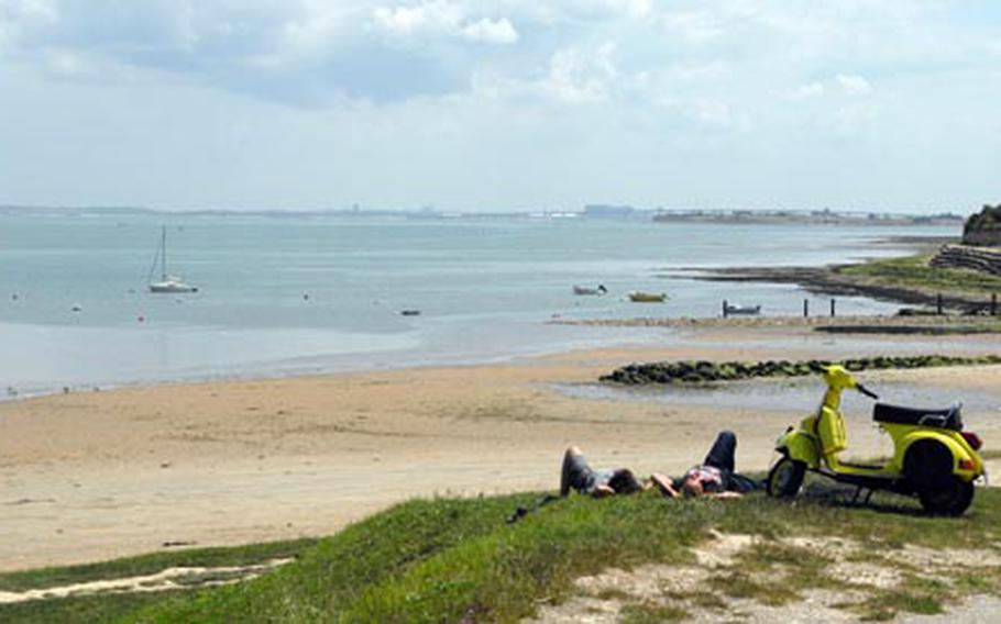 A couple take a break from a scooter ride along the coast of Il de Ré. This area is prime picking for mussels when the tide is out.