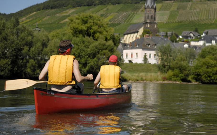 A canoe glides across the still waters of the Moselle River toward another scenic villiage on a crystal-clear day in early August. The Moselle is canoe-friendly, but with little or no current to be found, it is quite a workout to go any real distance.