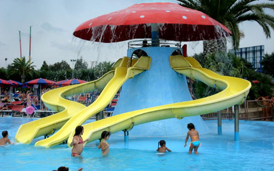 Children have a blast at the “giant mushroom” water slide in the kiddie pool section of Magic World’s water park.
