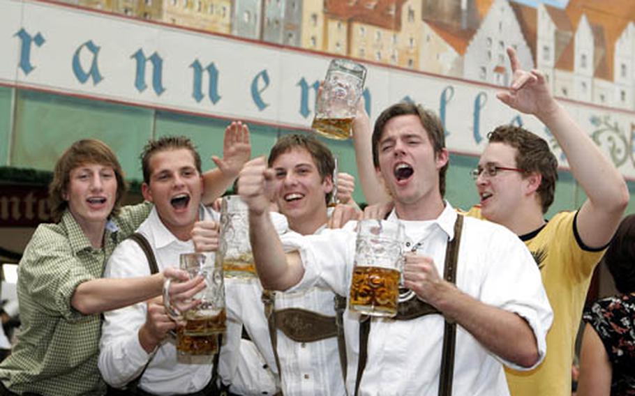 Young men pose with beer mugs during the last day of the 173rd beer festival Oktoberfest in Munich, southern Germany, on Oct. 3, 2006. This year's Oktoberfest begins Sept. 22