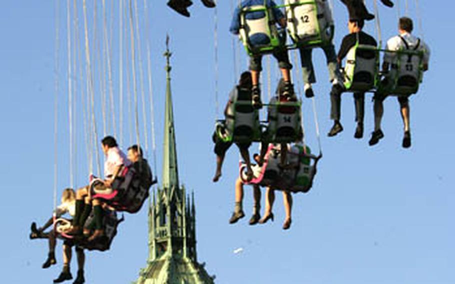Visitors fly high on a merry-go-round with the steeple of the St. Paul church in background on Sept. 22, 2007.