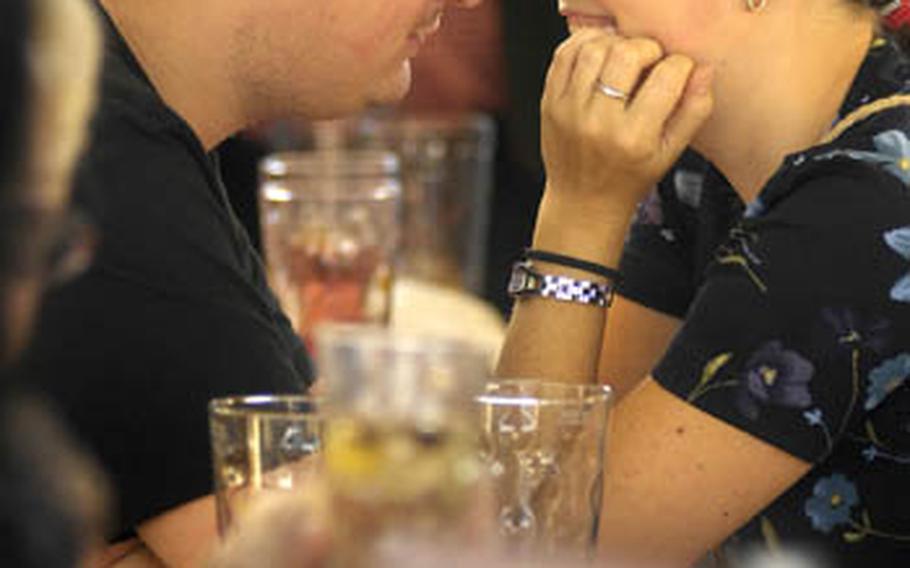 A couple enjoys an intimate moment across the narrow table of a wine tent in Bad Durkheim. The tents are considered the heart of the festival by the locals creating an atmosphere for lively conversation with old and new friends alike.