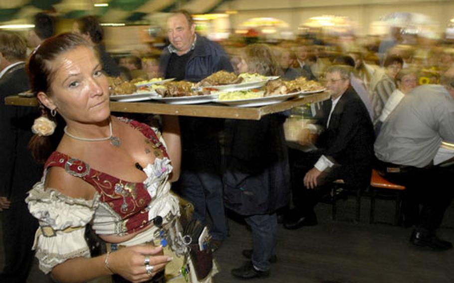 A waitress makes her way through one of many tents at the start of the legendary Wurstmarkt.