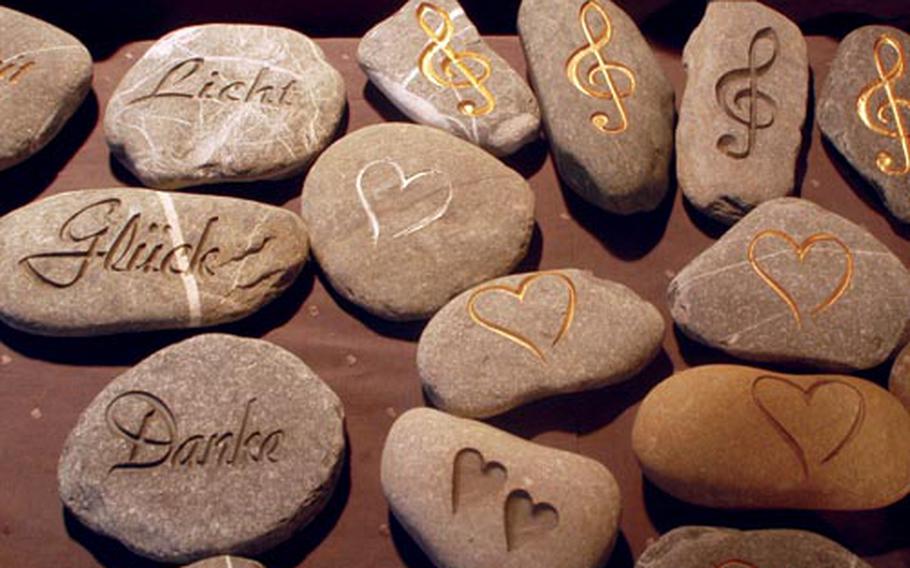 Stones chiseled with messages are sold as paperweights. The stones’ messages at left read, from top to bottom: light, luck and thanks.