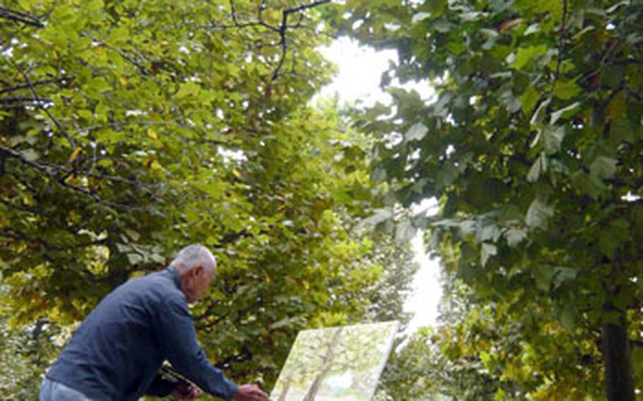 A man paints tulip trees planted at Shinjuku Gyoen National Garden. The trees are among 20,000 kinds of plants growing in the garden.